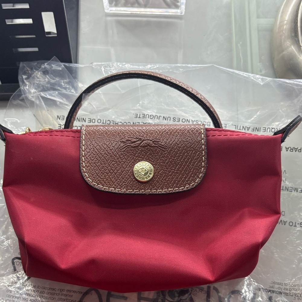 Longchamp Cherry Mini Bag with Textured Brown Flap
Brand New 
Copy